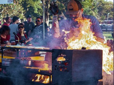 Man grilling in the park with family and friends