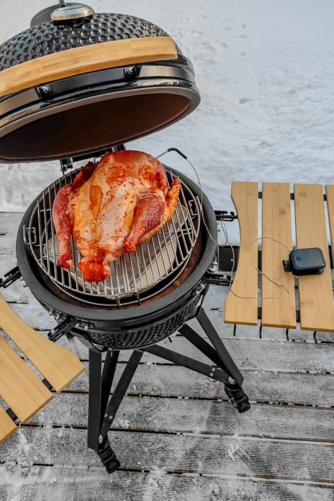 Grilling a turkey in the snow on a grill.