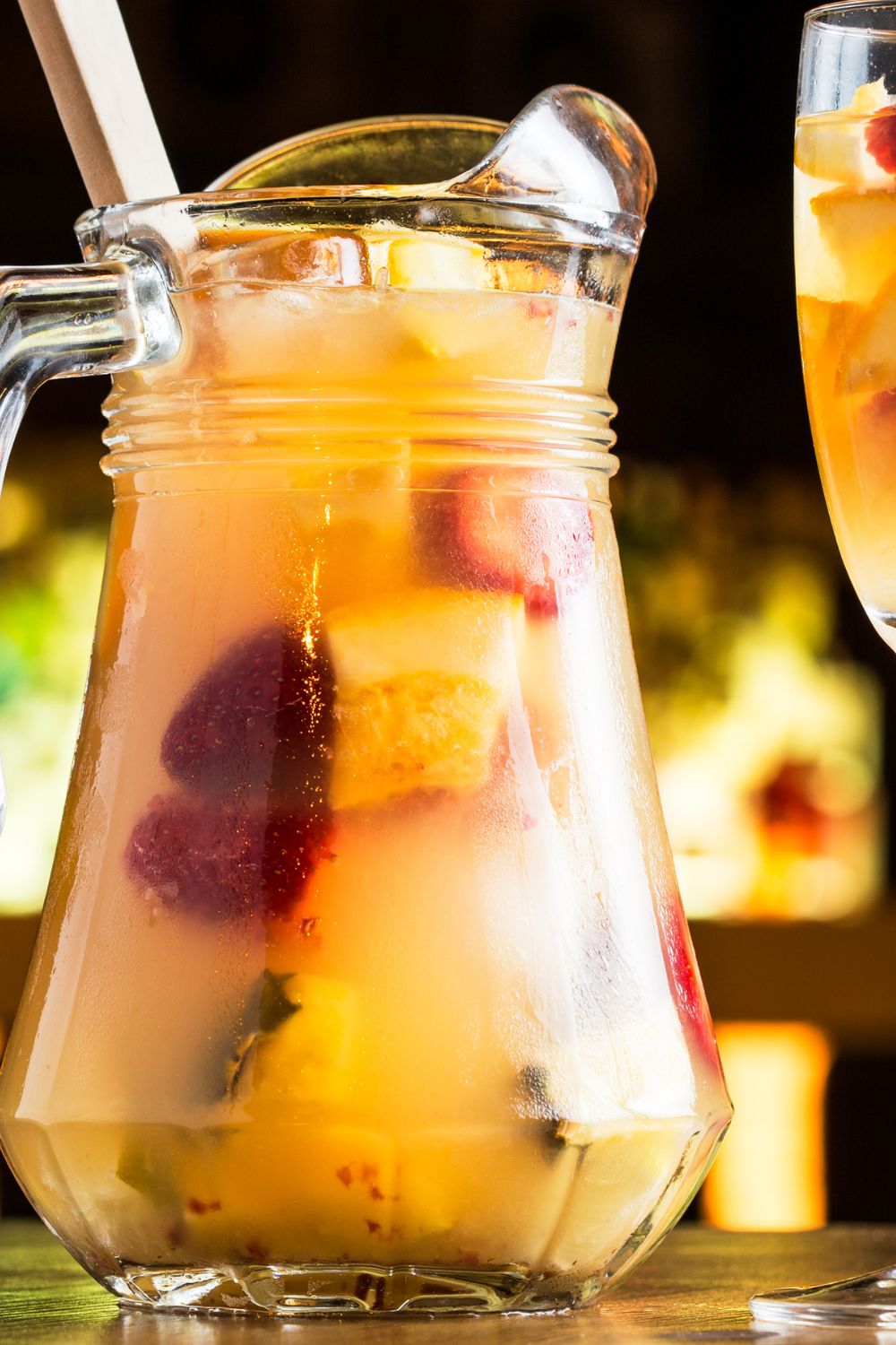 A pitcher filled with breakfast sangria and fruits