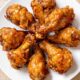 A circle of apple butter brown sugar wings on a white plate