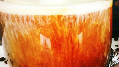 bourbon coffee cocktail in a glass with a little cream and a foam top