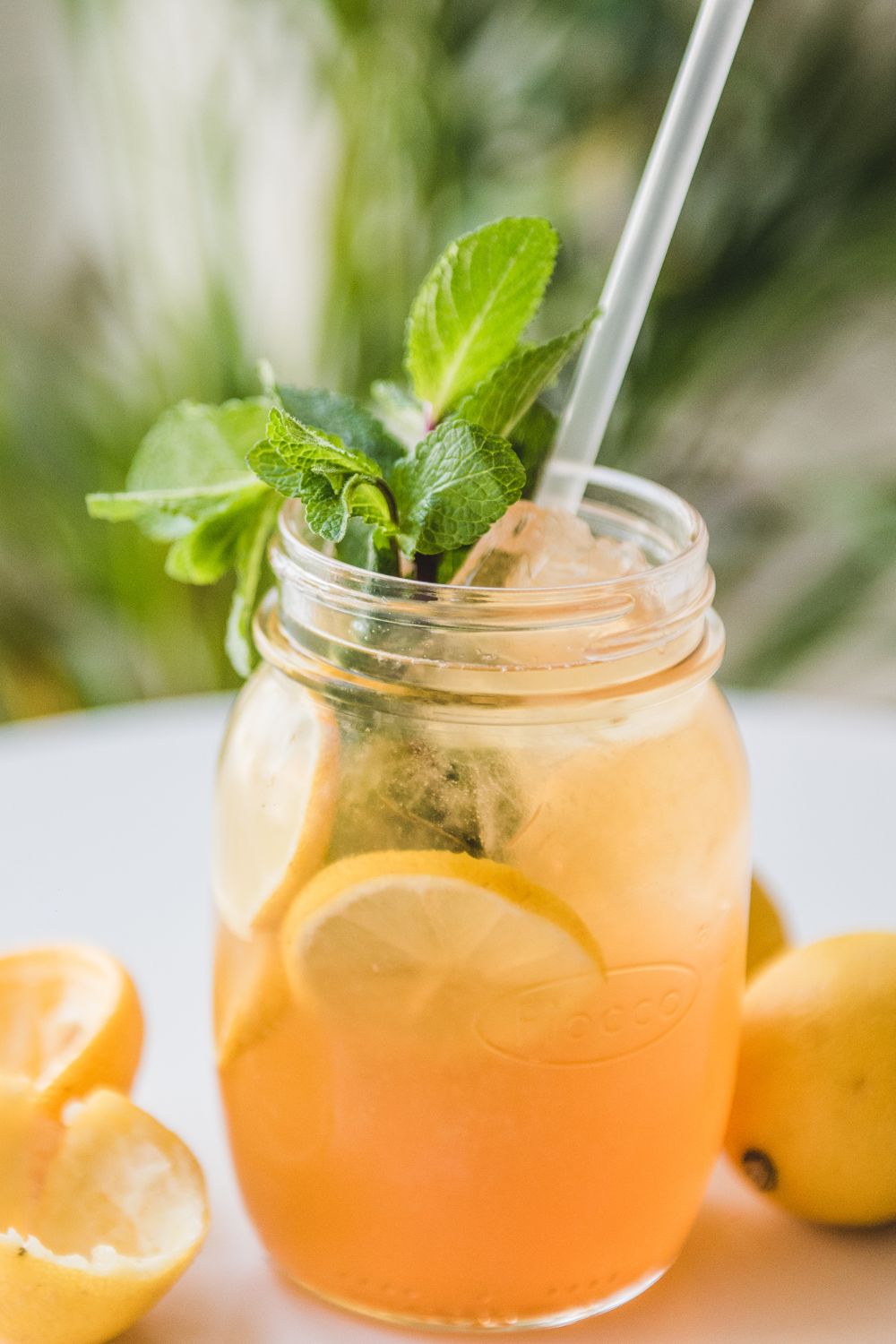 cajun lemonade in a mason jar with mint leaves and a straw