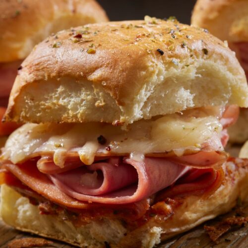 A close image of a croque monsieur slider with ham and cheese