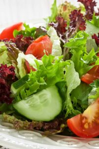 A green jacket salad with cherry tomatoes, lettuce and cucumber