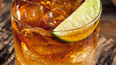 Dark and stormy coffee in a glass garnished with a lime wedge