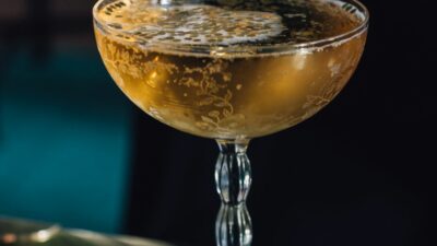 A jockey club cocktail in a coup glass