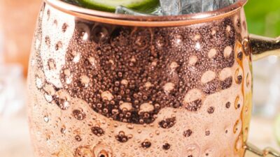 A kentucky mule in a copper mug garnished with lime slices