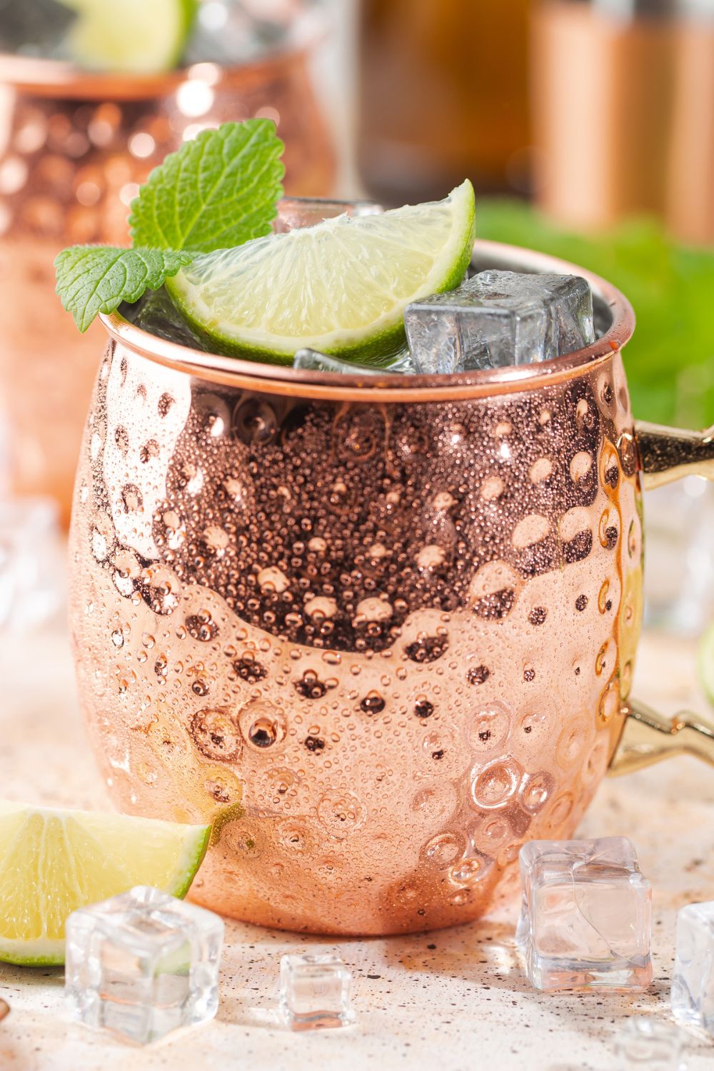 A kentucky mule in a copper mug garnished with lime slices