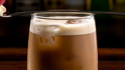 A prairie buzz cocktainl in a glass with a foam topper