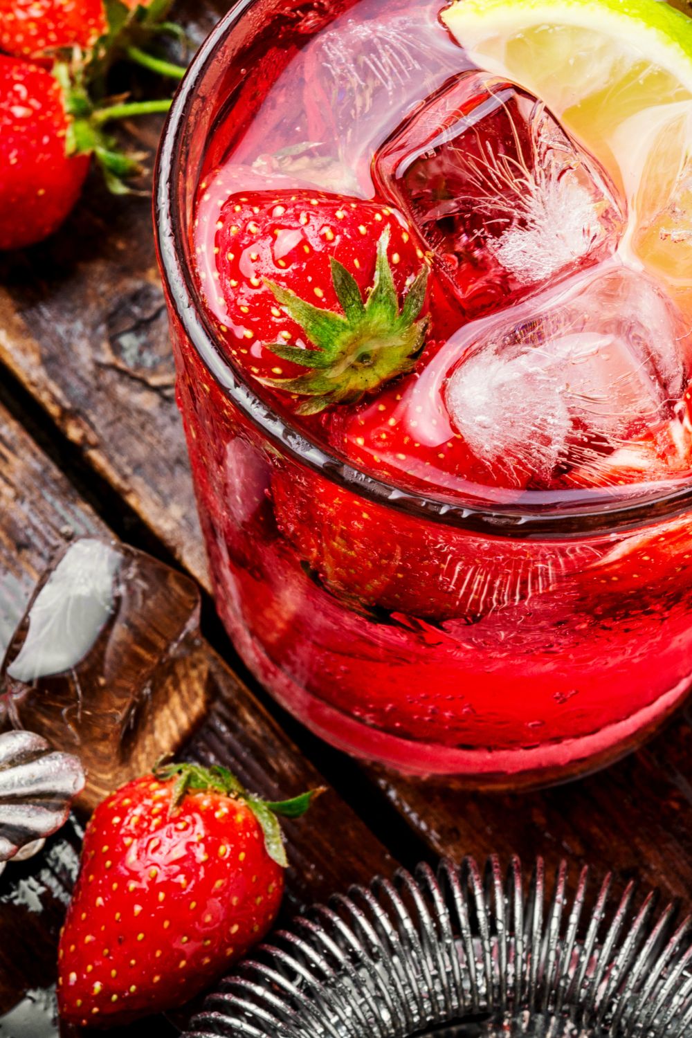 A southern sweet tea jam drink in a glass garnished with strawberries