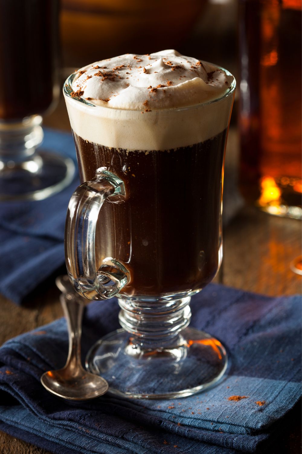 A kentucky coffee drink in a glass mug topped with whipped cream.