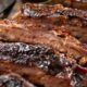 A plate of bbq baby back ribs.