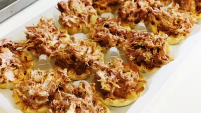 Pork side bites in mini phyllo cups on a serving tray.