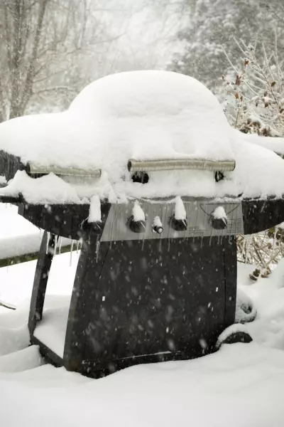 How To Make Hosting Thanksgiving Easier 3 An outdoor grill covefred in snow.