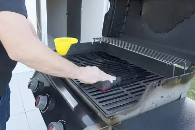 Tips To Make Your Tailgate Food Grill Like Brand New Again 3 bigstock The Male Hand Cleans The Black 331616407