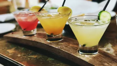 three drinks on a serving tray; pitcher cocktail recipes for tailgating