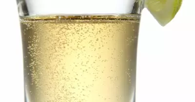 A par four shot in a shot glass with a lime wedge