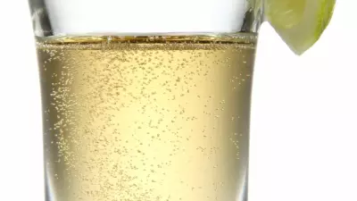 A par four shot in a shot glass with a lime wedge