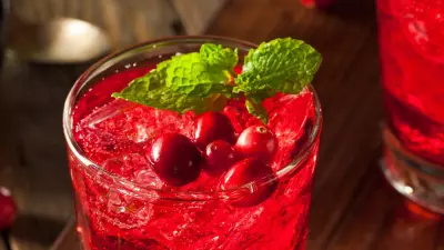 A tiger woods cocktail in a highball glass garnished with mint