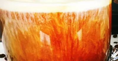 bourbon coffee cocktail in a glass with a little cream and a foam top
