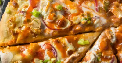 An overhead shot of half of a buffalo chicken pizza