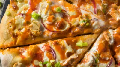 An overhead shot of half of a buffalo chicken pizza