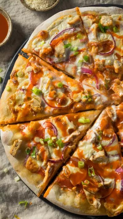 An overhead shot of half of a buffalo chicken pizza