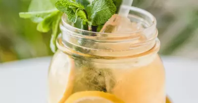 cajun lemonade in a mason jar with mint leaves and a straw