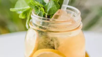 cajun lemonade in a mason jar with mint leaves and a straw