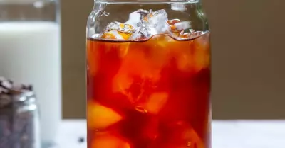 An Oaxacan Tail Cocktail in a glass with milk in the background