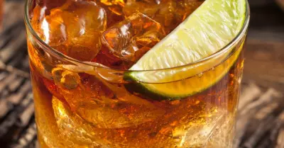 Dark and stormy coffee in a glass garnished with a lime wedge