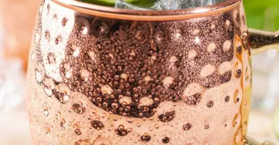 A kentucky mule in a copper mug garnished with lime slices