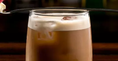 A prairie buzz cocktainl in a glass with a foam topper
