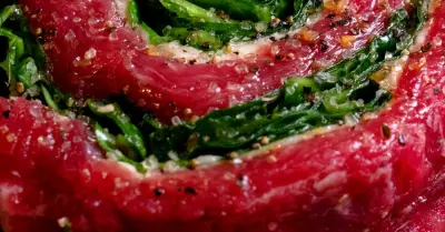 A skirt steak wrapped in a pinwheel stuffed with greens