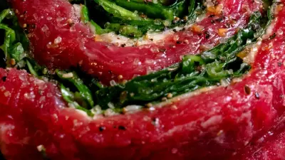 A skirt steak wrapped in a pinwheel stuffed with greens