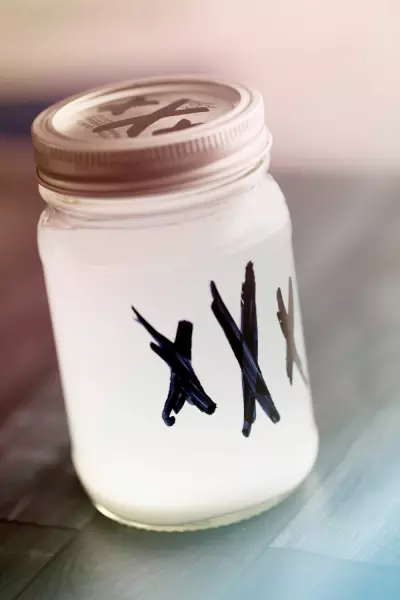 Watermelon Moonshine Recipe 4 Leftover moonshine in a mason jar labeled with three X's