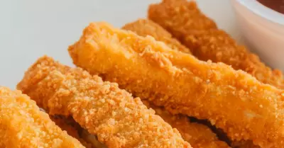 Air fried chicken fries on a white plate with sauce.