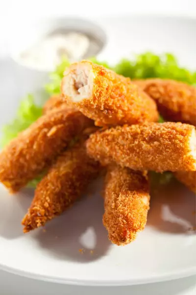 Chicken Fries in Air Fryer 2 A group of chicken fries that were air fried on a plate.
